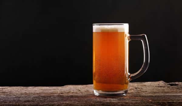 A pint of amber lager on a bar