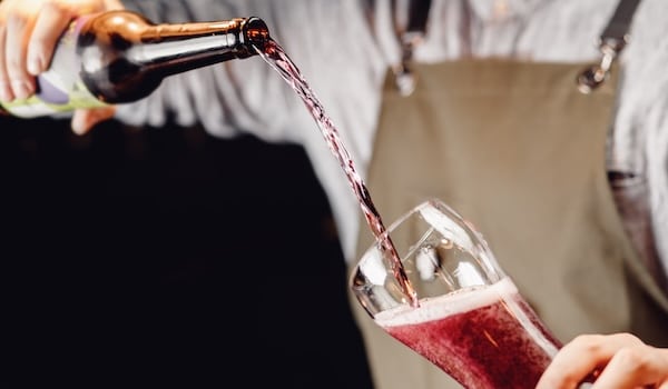 barman pouring blueberry beer