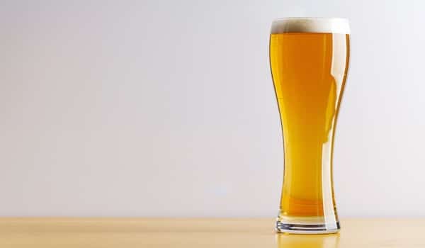 pint of lager beer on a wooden table