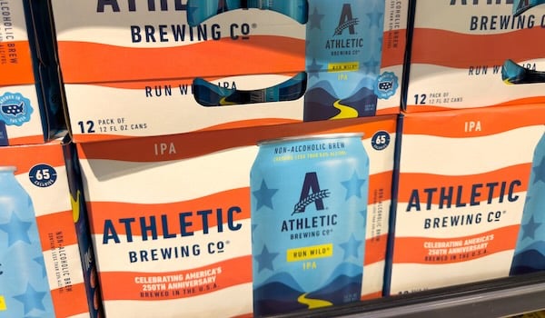 Athletic Brewing - Run Wild IPA non-alcoholic beer boxes on a shelf.