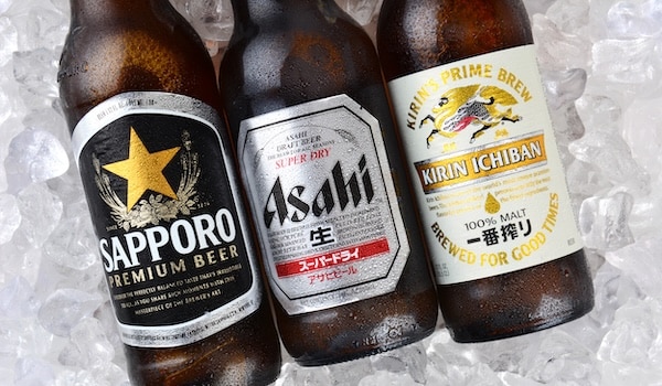bottles on japanese lager beers on ice, including asahi, sapporo and kirin ichiban