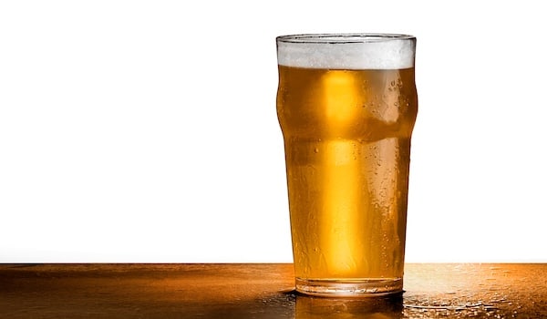 How os lager beer made - ice cold pint of pale lager beer on a bar